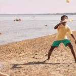 kids playing pickleball on beach